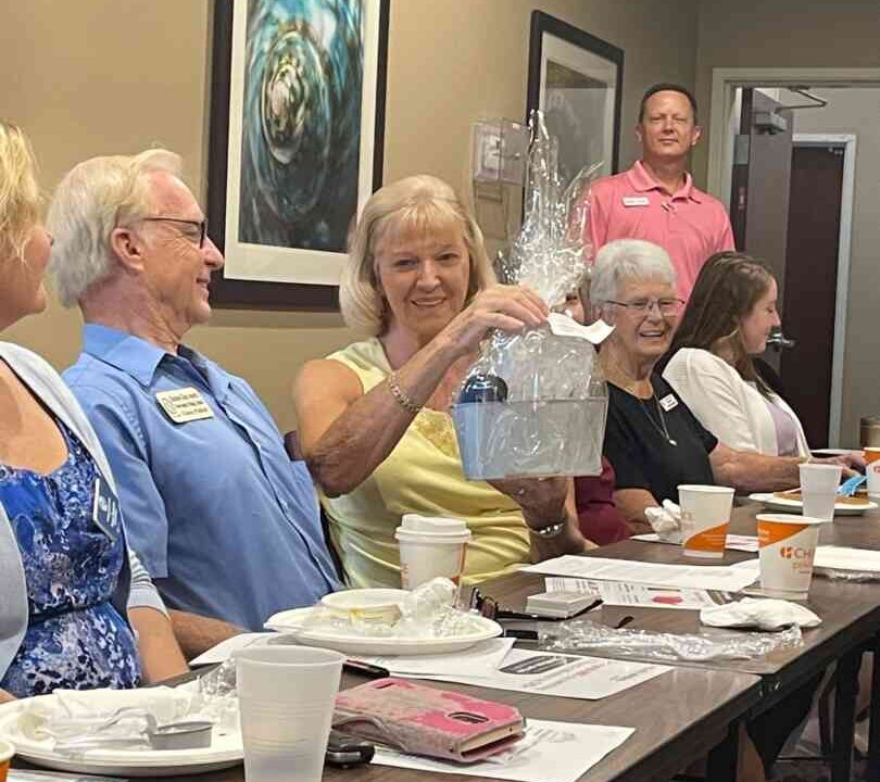 Member Kathy with Kustom Glass wins a prize during the raffle portion of our breakfast networking meeting.